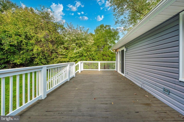 wooden terrace with a yard