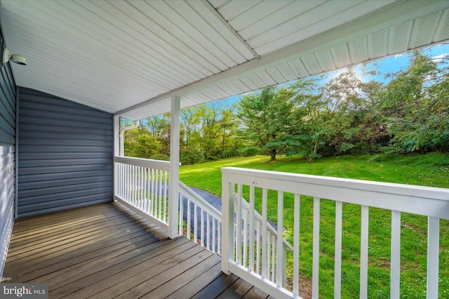 wooden terrace with a lawn