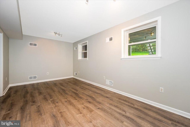 spare room with dark hardwood / wood-style flooring