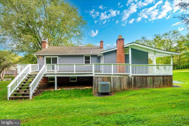 rear view of house with a lawn, central AC, and a wooden deck