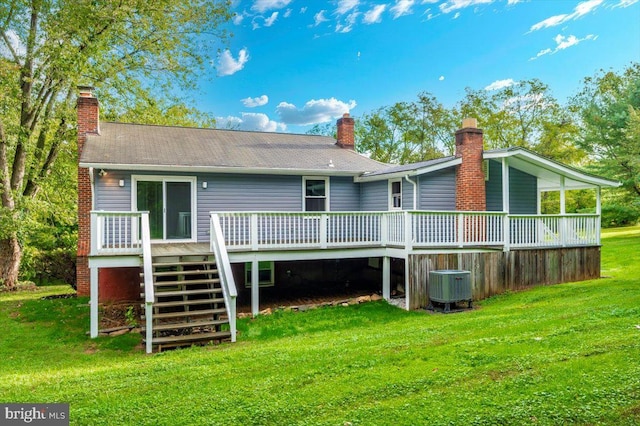 back of house with a wooden deck, central air condition unit, and a lawn