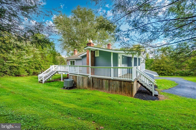 exterior space featuring central AC unit and a yard