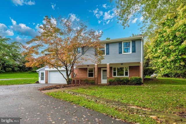 view of front of property with a porch, a garage, and a front lawn