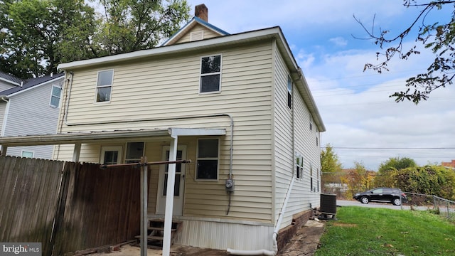 rear view of property featuring central AC unit