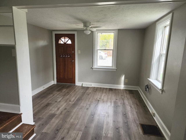 entryway featuring a textured ceiling, ceiling fan, and dark hardwood / wood-style flooring