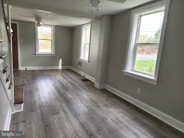 empty room featuring ceiling fan and dark hardwood / wood-style floors