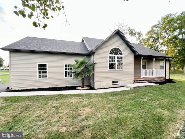 rear view of house featuring a yard