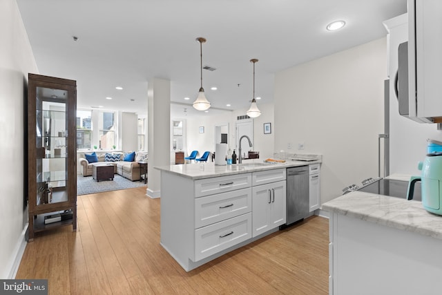 kitchen with light wood-type flooring, hanging light fixtures, stainless steel dishwasher, and white cabinets