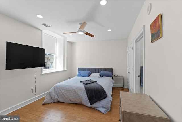 bedroom with wood-type flooring and ceiling fan