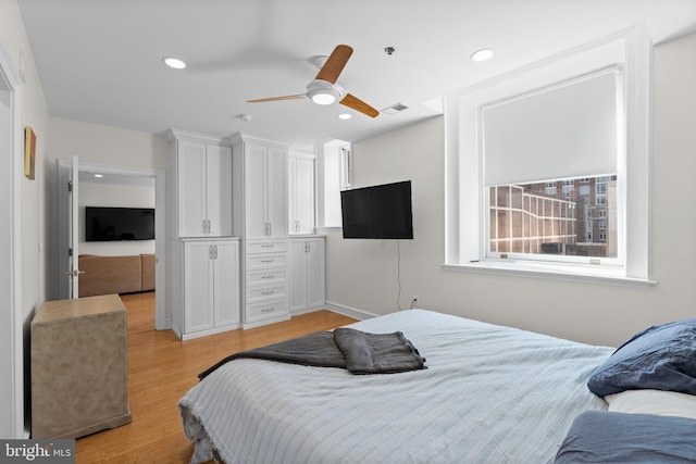 bedroom with ceiling fan and light hardwood / wood-style floors