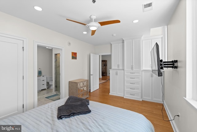 bedroom featuring light hardwood / wood-style floors, ceiling fan, and ensuite bathroom