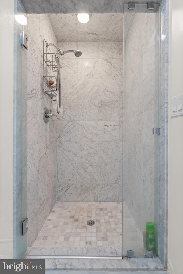 bathroom with a shower with door