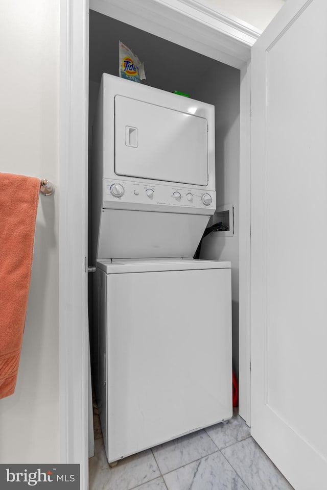 washroom featuring stacked washing maching and dryer