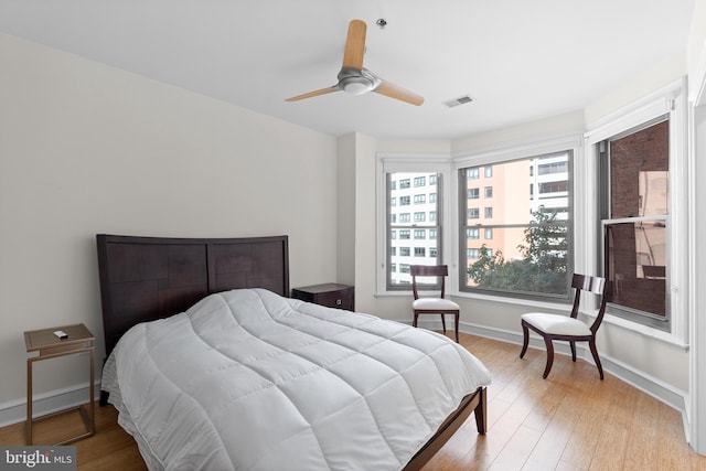 bedroom with ceiling fan and light hardwood / wood-style flooring