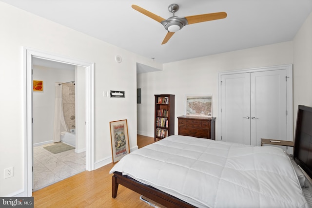 bedroom with ceiling fan, a closet, light hardwood / wood-style flooring, and ensuite bathroom