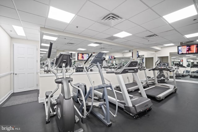 exercise room with a paneled ceiling