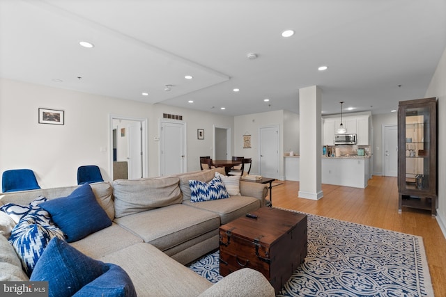 living room with light hardwood / wood-style flooring