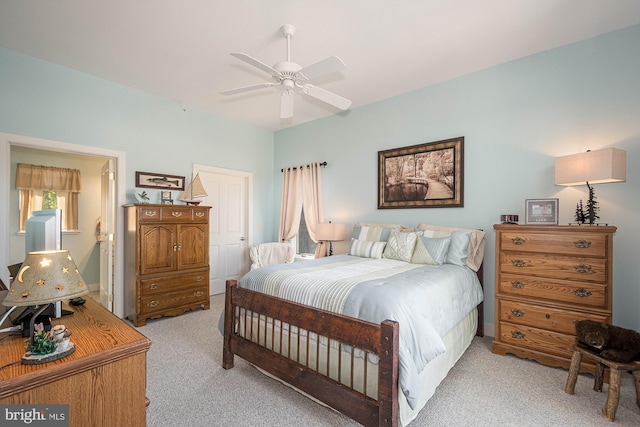 bedroom featuring ceiling fan and light carpet