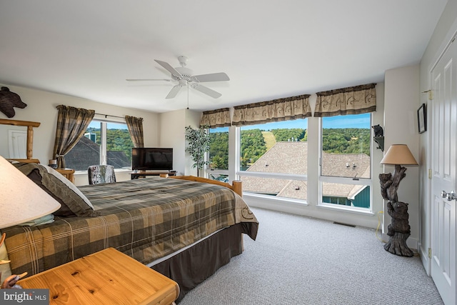 bedroom with ceiling fan and carpet