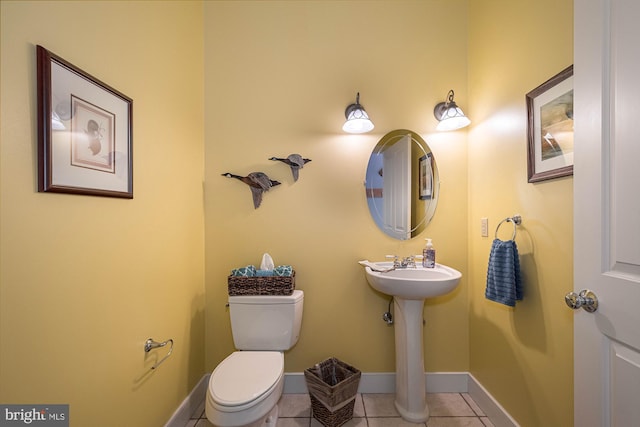 bathroom featuring sink, toilet, and tile patterned floors