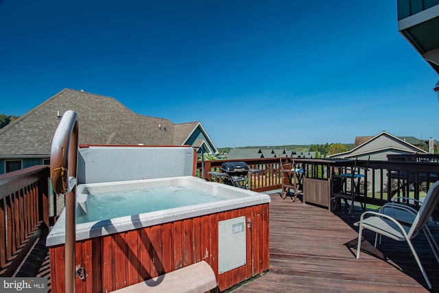 wooden terrace featuring a hot tub