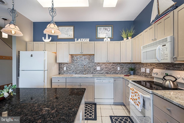 kitchen featuring light stone counters, tasteful backsplash, sink, white appliances, and decorative light fixtures