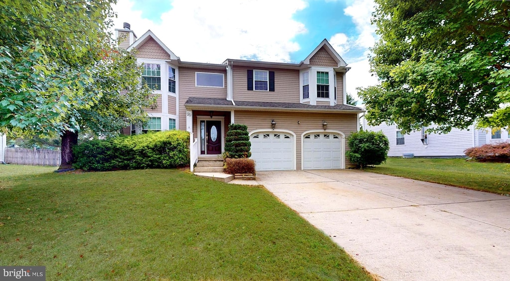 view of front of property with a front yard and a garage