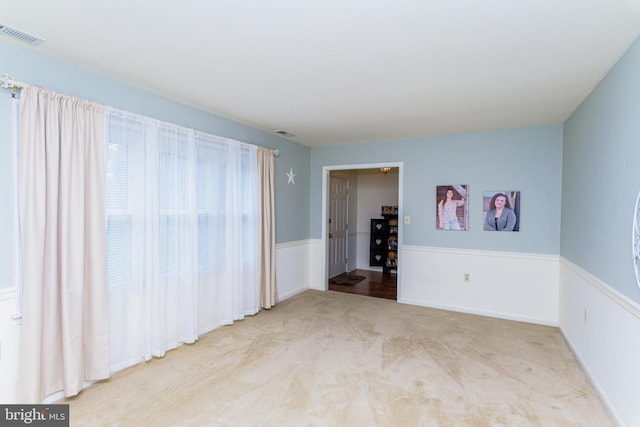 unfurnished room with light carpet