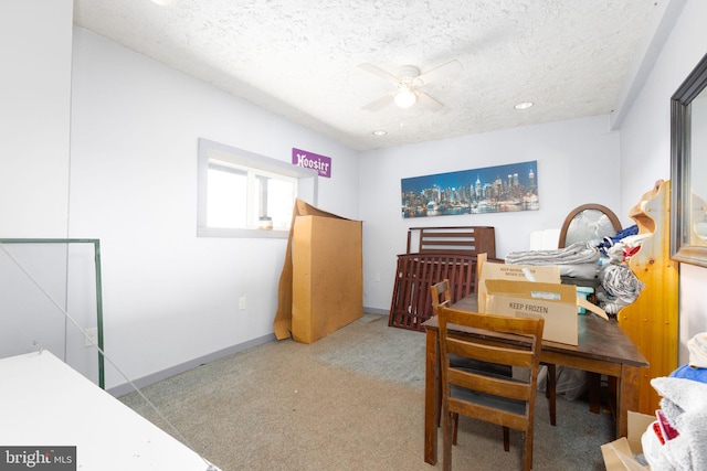 interior space featuring a textured ceiling, carpet floors, and ceiling fan