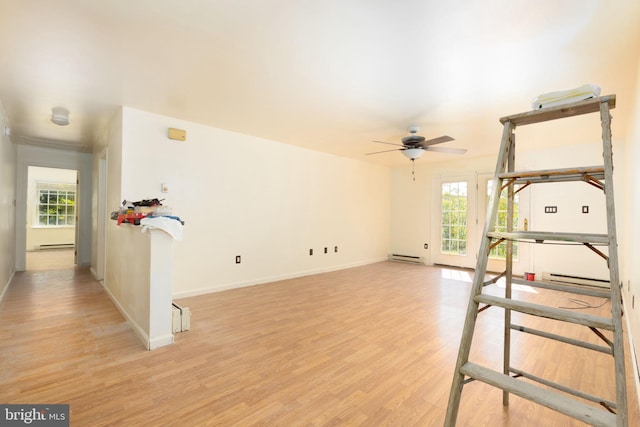 interior space featuring light hardwood / wood-style floors, baseboard heating, and ceiling fan