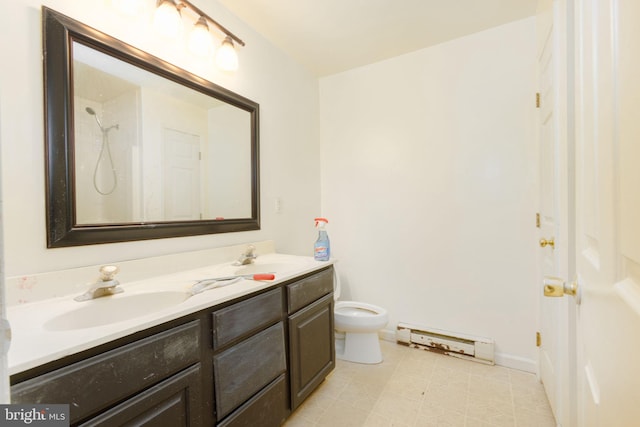 bathroom with a shower, vanity, toilet, and a baseboard radiator