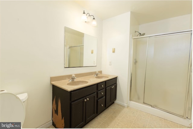 bathroom featuring walk in shower, vanity, tile patterned flooring, and toilet