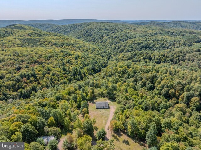 birds eye view of property featuring a view of trees