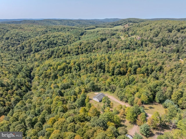 drone / aerial view with a wooded view