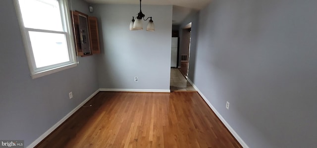 unfurnished dining area featuring hardwood / wood-style flooring