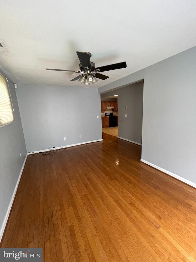 spare room featuring ceiling fan and wood-type flooring