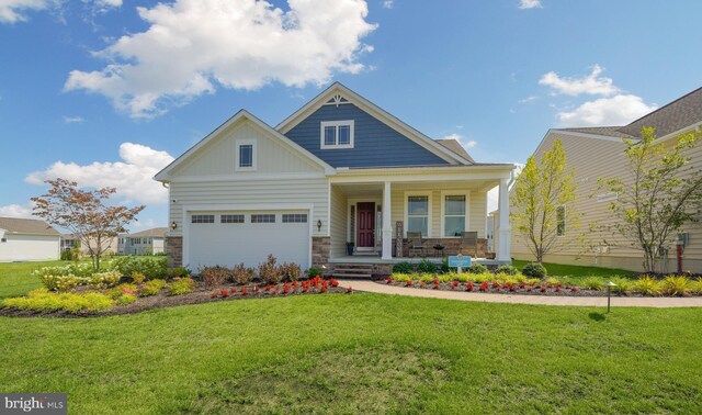 craftsman inspired home featuring a garage, a front yard, and covered porch