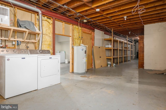 basement with water heater and washer and dryer