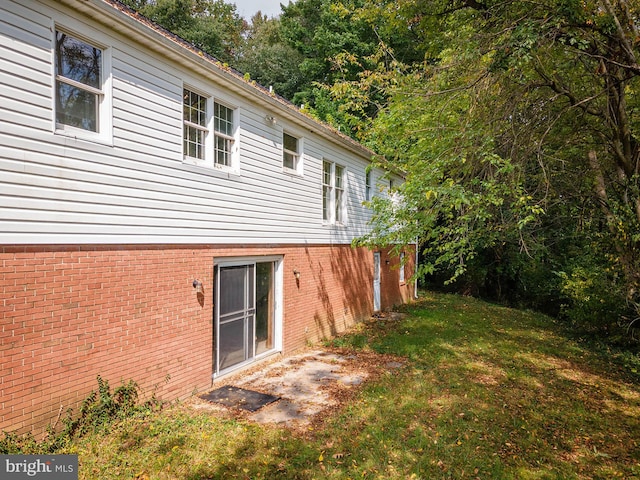 view of side of property with a yard