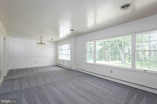 carpeted empty room with a notable chandelier and a baseboard radiator