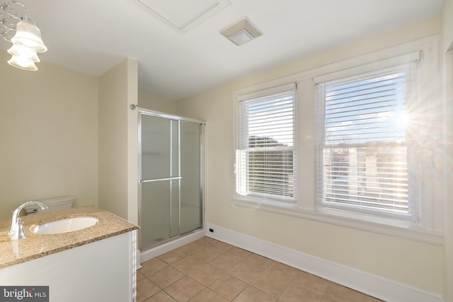 bathroom featuring tile patterned floors, a shower with door, vanity, and toilet