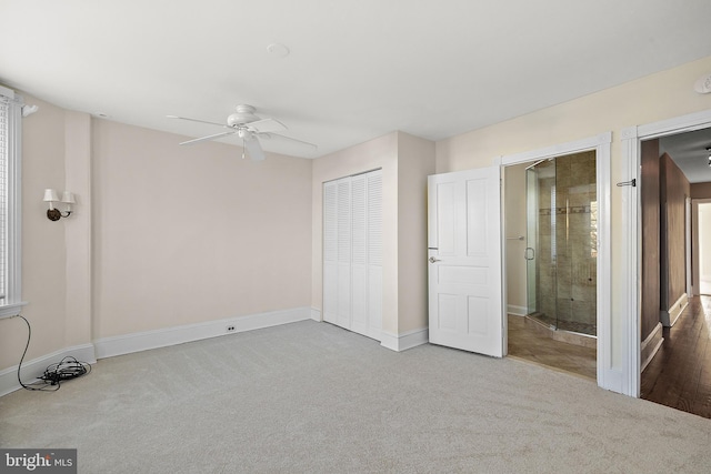 unfurnished bedroom with ceiling fan, light carpet, and a closet