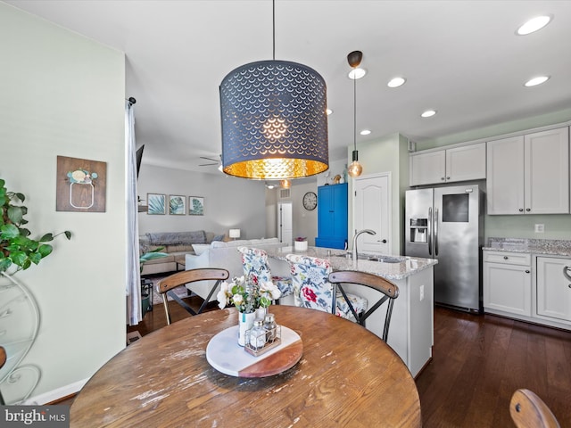 dining area with sink and dark hardwood / wood-style flooring