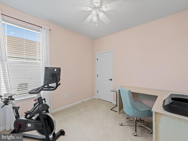 office space with light colored carpet and ceiling fan