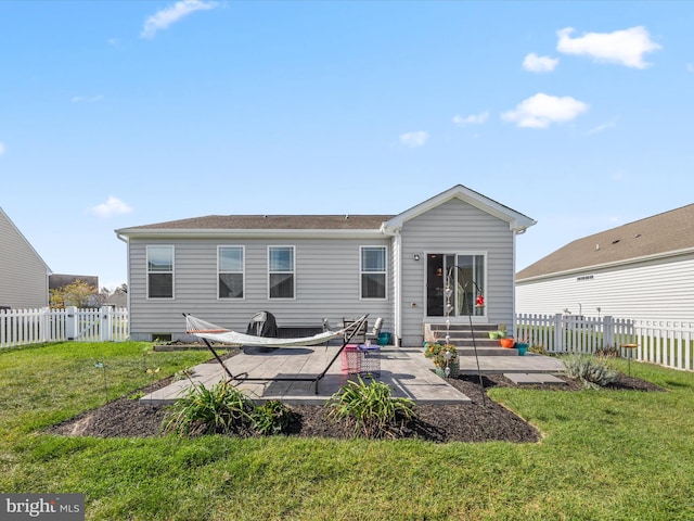 rear view of house featuring a patio and a lawn