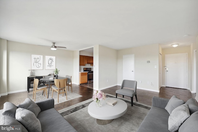 living room featuring dark hardwood / wood-style flooring and ceiling fan