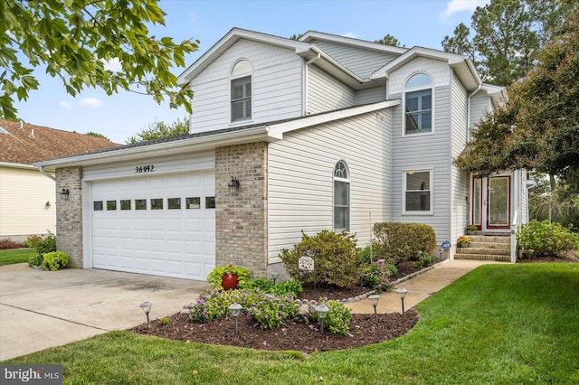 front facade featuring a garage and a front lawn