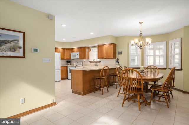 tiled dining area with sink and a notable chandelier