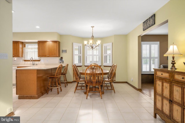 dining room featuring an inviting chandelier, plenty of natural light, and light tile patterned floors