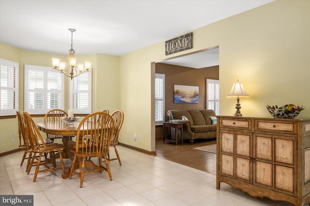 dining space featuring a notable chandelier, light hardwood / wood-style floors, and a wealth of natural light